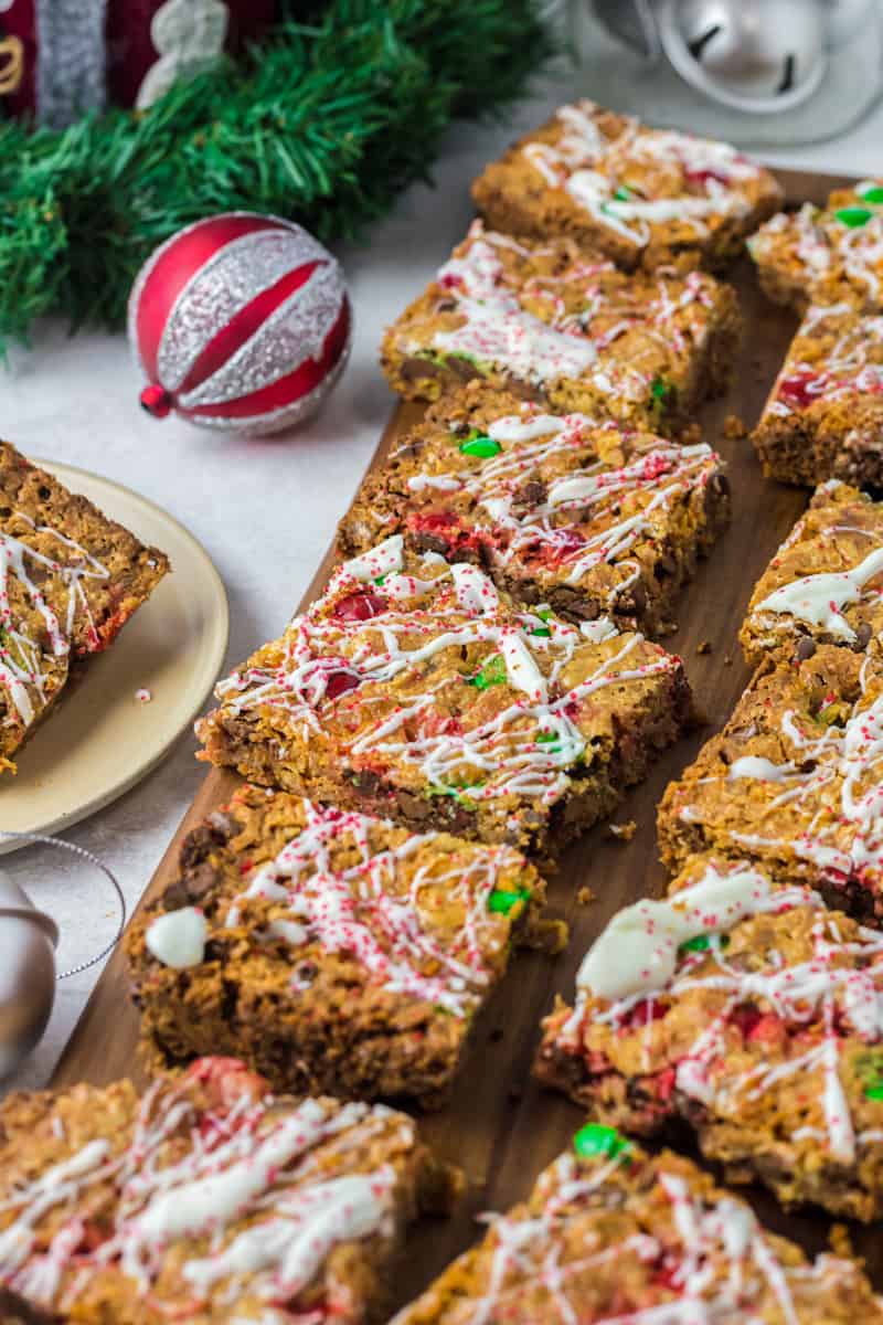 christmas 7 layer magic cookie bars on a wood board