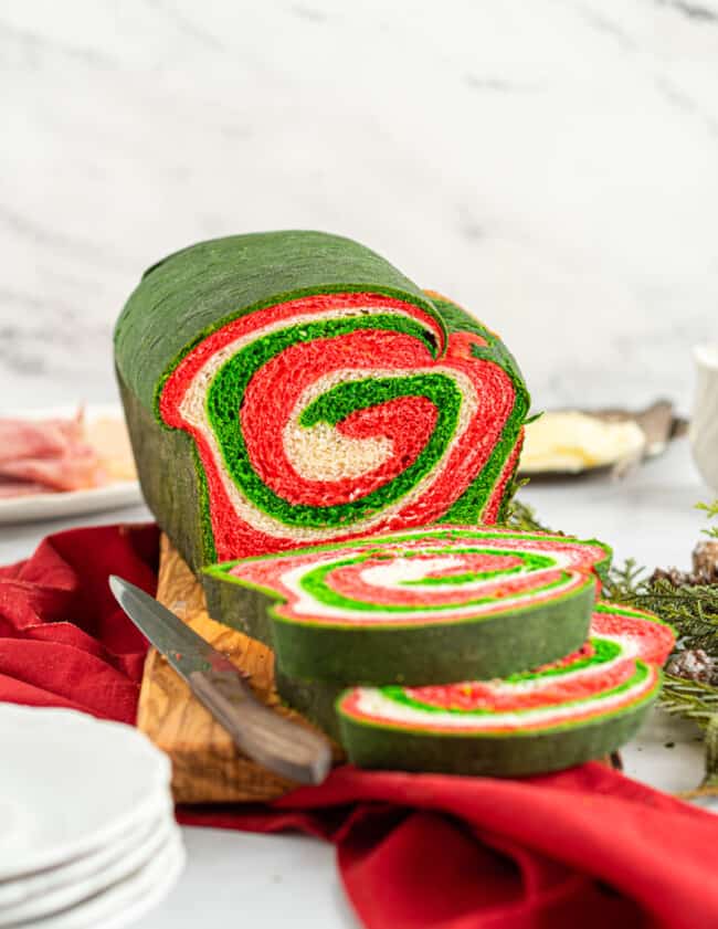 christmas swirl bread with a slice removed showing the swirl inside