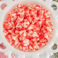 red and white cream cheese mints in a white bowl