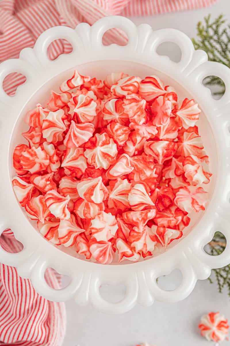 red and white cream cheese mints in a white bowl