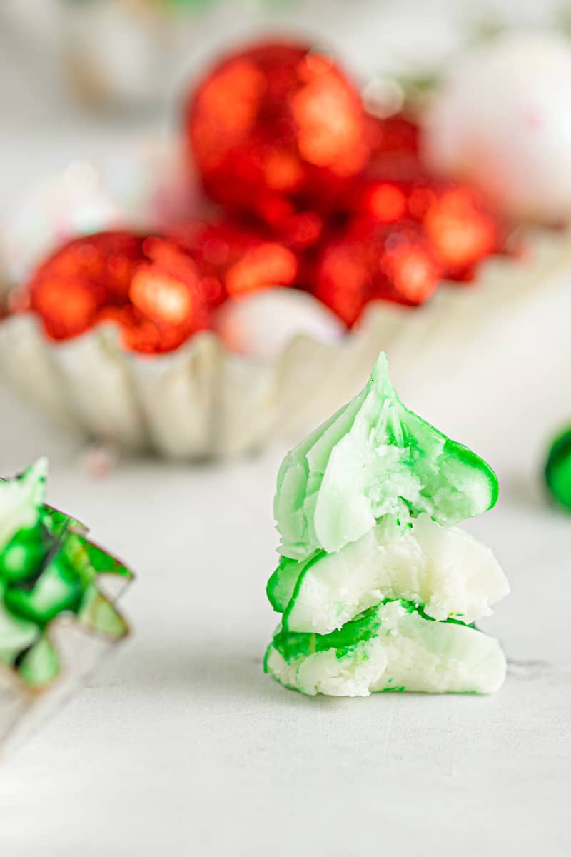 stack of green and white cream cheese mints with bites taken from them