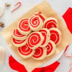 white and red pinwheel cookies on a white plate