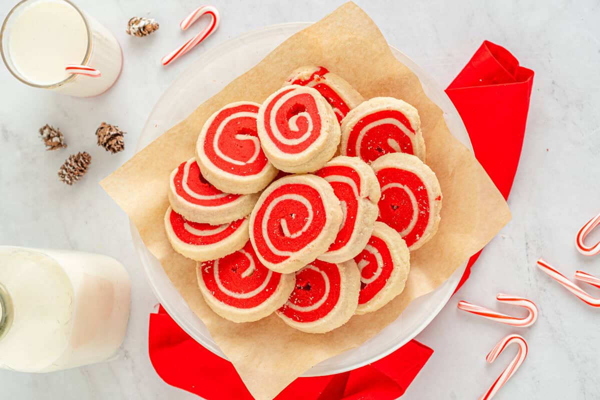 white and red pinwheel cookies on a white plate