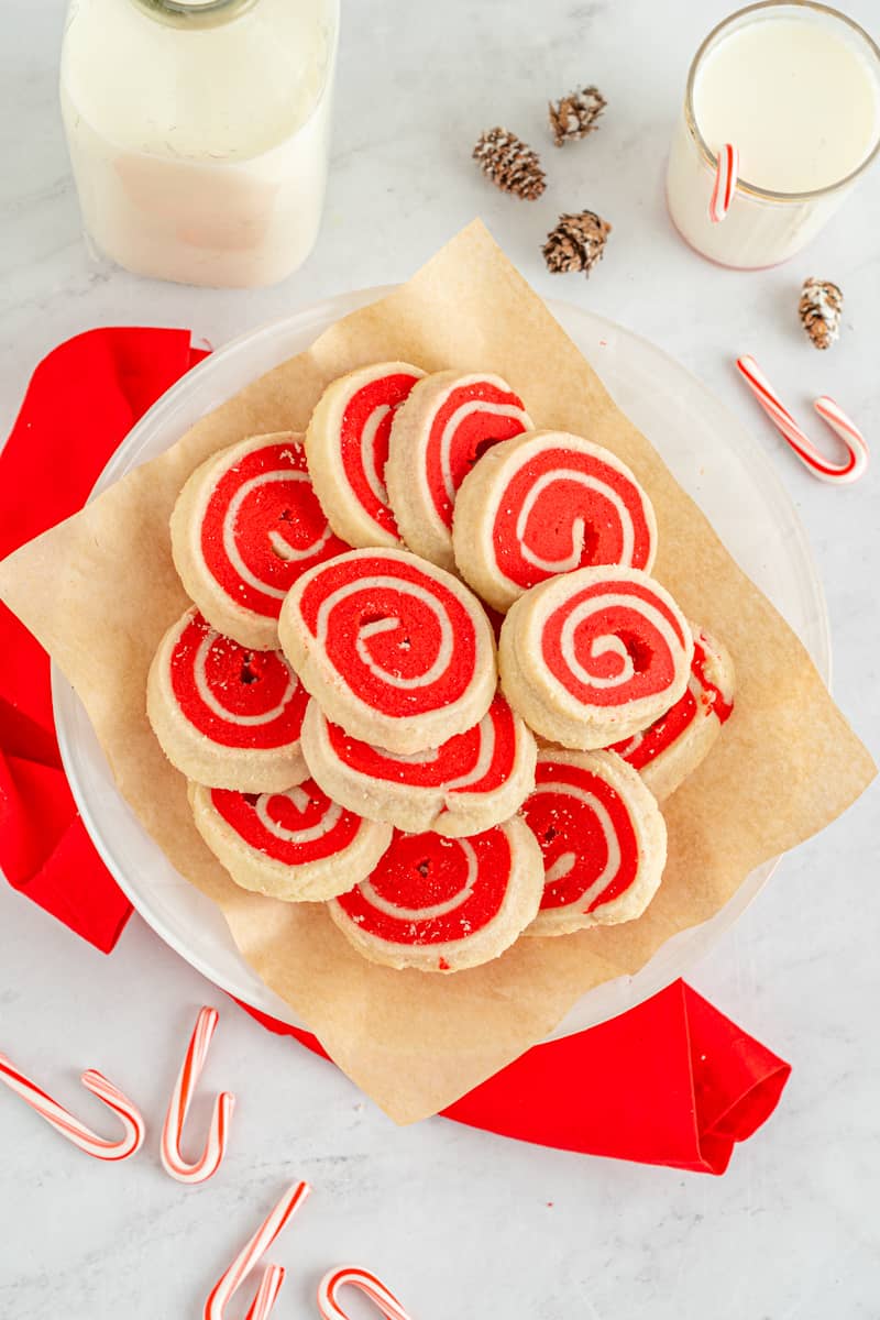 white and red pinwheel cookies on a white plate