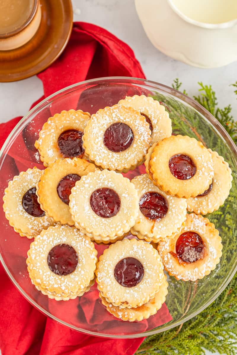 overhead image of linzer cookies on a glass cake stand