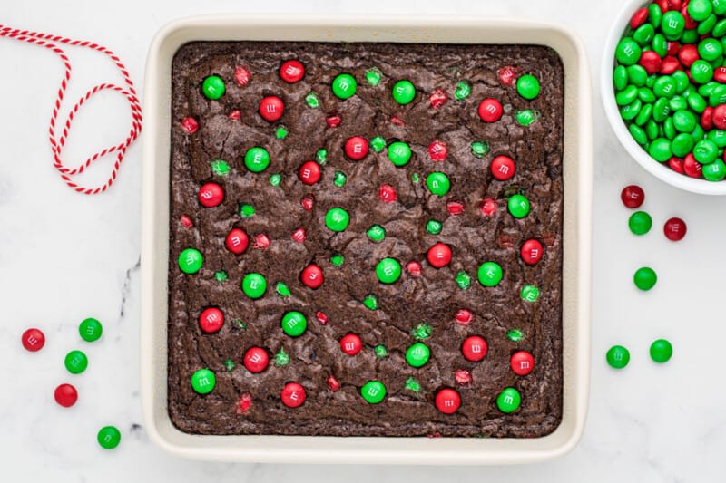 brownies with christmas M&Ms in a white baking dish after baking