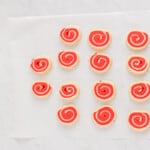 white and red pinwheel cookies on parchment paper before baking