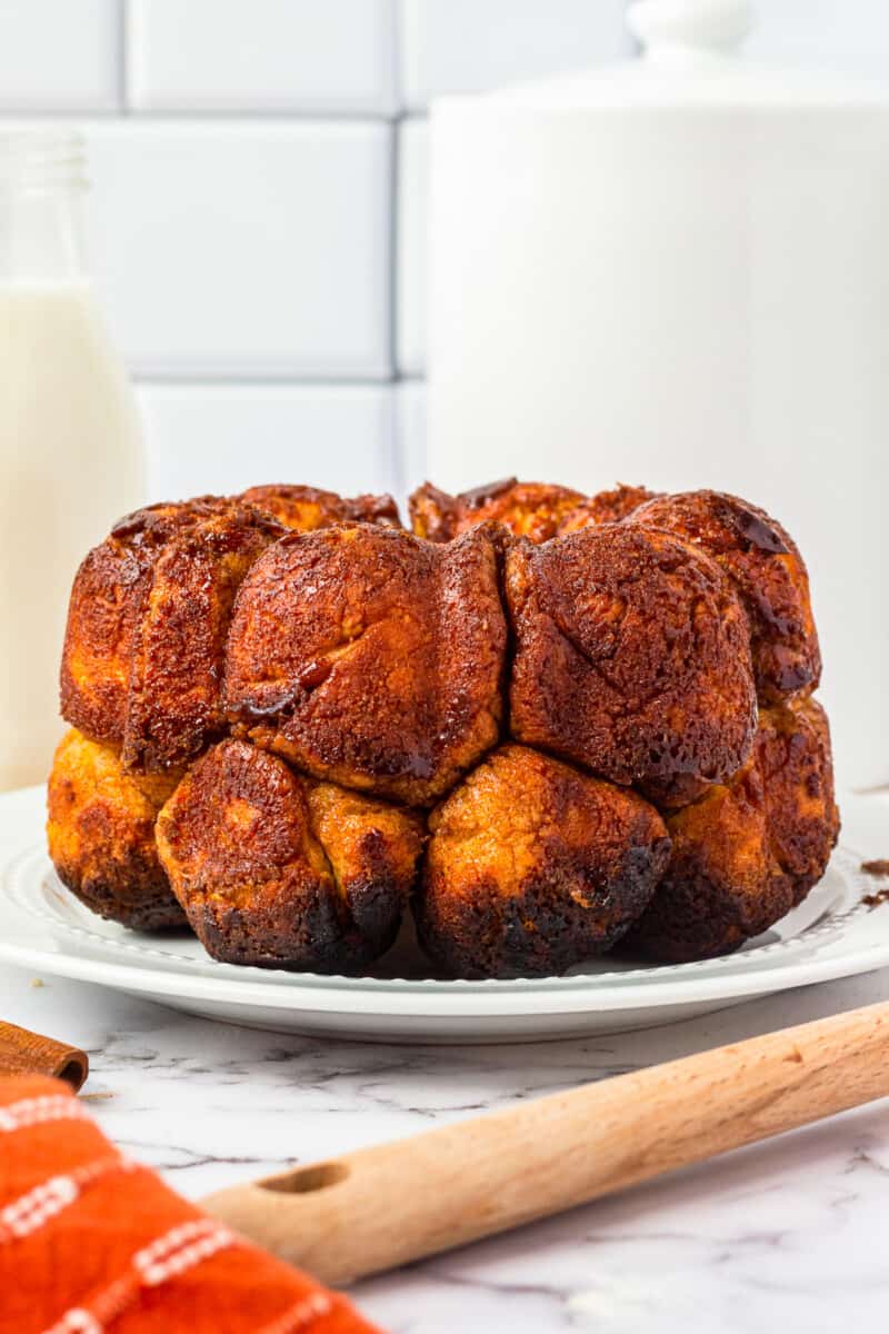 side view of monkey bread on a white serving plate