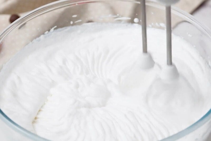 beating cream and powdered sugar to stiff peaks with a hand mixer.