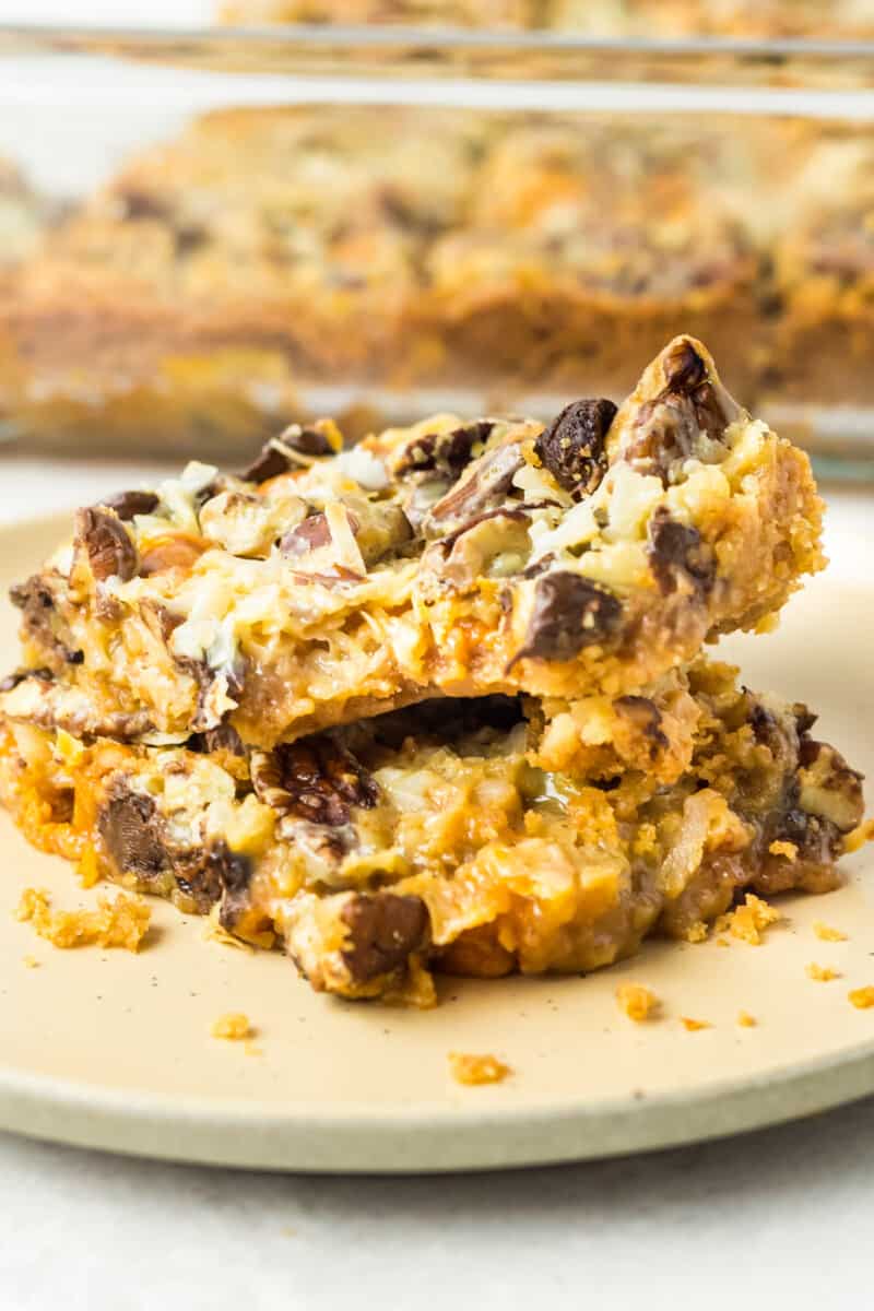 stack of 2 7 layer magic cookie bars on a plate