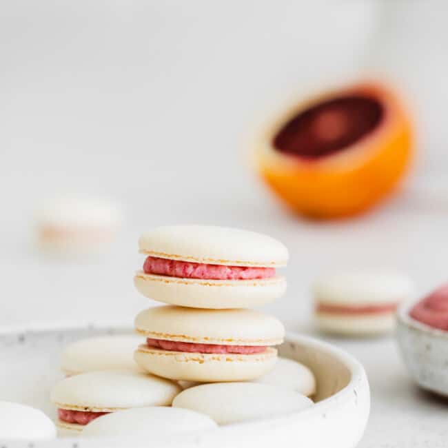 stack of blood orange macarons on a plate