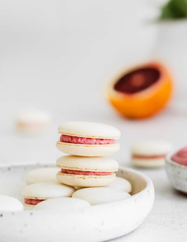 stack of blood orange macarons on a plate