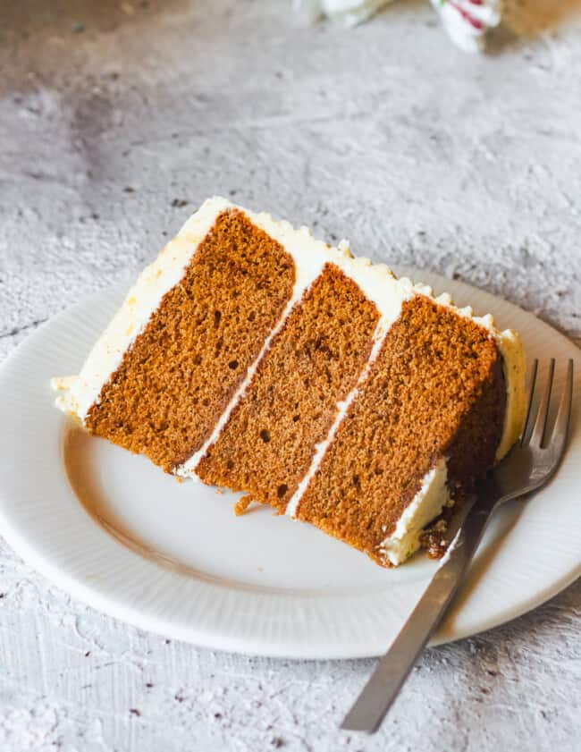 slice of brown butter spice cake on a white plate with a fork
