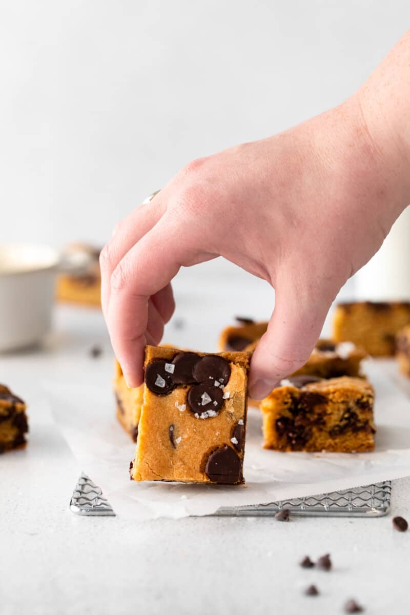 hand grabbing a chocolate chip cookie bar