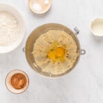 eggs added to creamed butter and sugar in a metal bowl