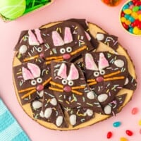pieces of easter bunny chocolate bark on a wood board