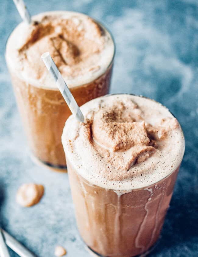 2 glasses of chocolate frosty drink with straws