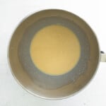 yeast and milk in a metal bowl