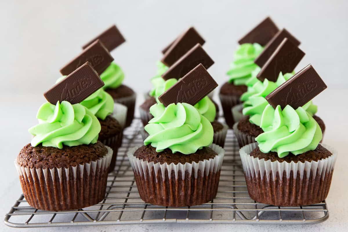 andes mint cupcakes topped with green mint buttercream frosting and andes chocolates