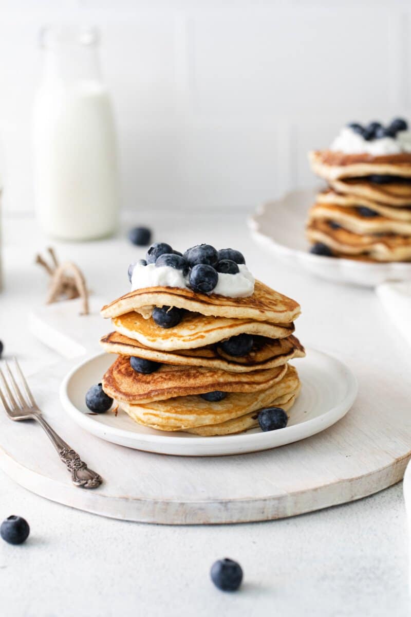 stack of blueberry pancakes on a white plate