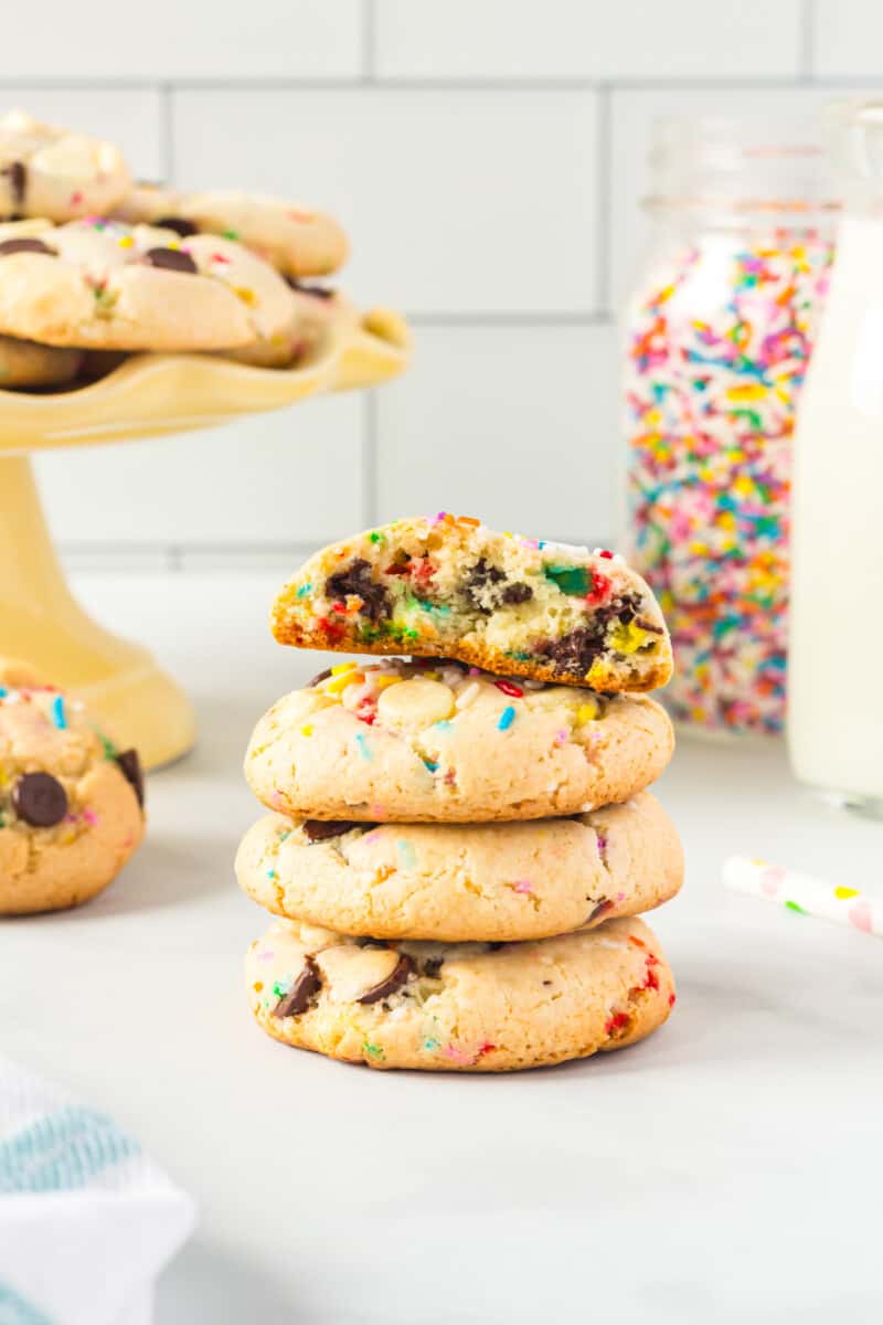 stack of 4 cake batter cookies with a bite taken from the top cookie