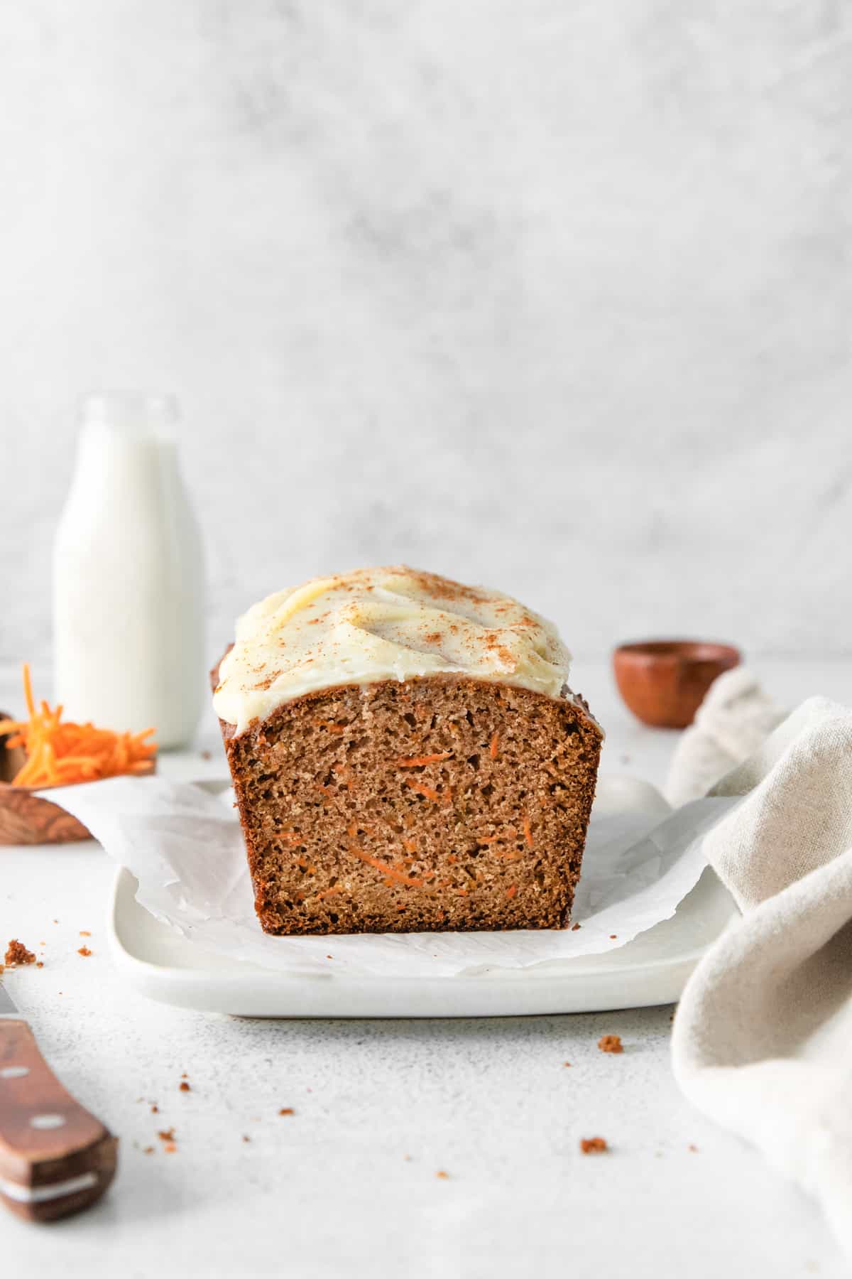 carrot bread on a white serving platter with a slice removed showing the texture
