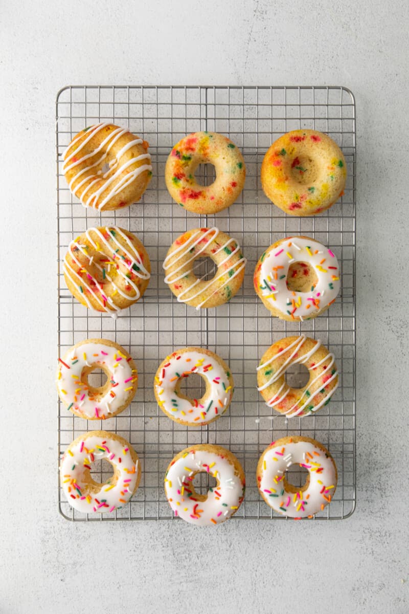 overhead image of funfetti donuts on a cooling rack