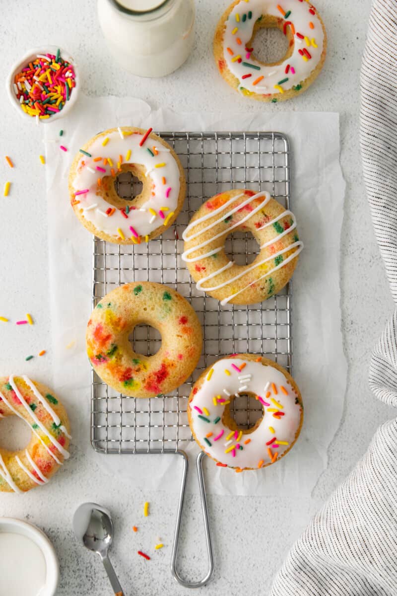 overhead image of funfetti donuts on a cooling rack
