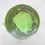 green mint buttercream frosting in a metal bowl