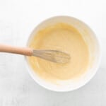 cupcake batter in a white bowl with a whisk