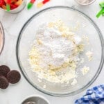 powdered sugar with creamed butter and cream cheese in a glass bowl