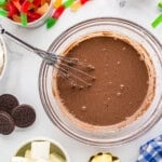 chocolate pudding in a glass bowl with a whisk