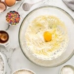 eggs added to wet ingredients in a glass bowl