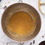wet ingredients for chocolate chip cookie cake in a metal bowl