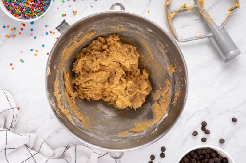 cookie cake cookie dough without chocolate chips in a metal bowl