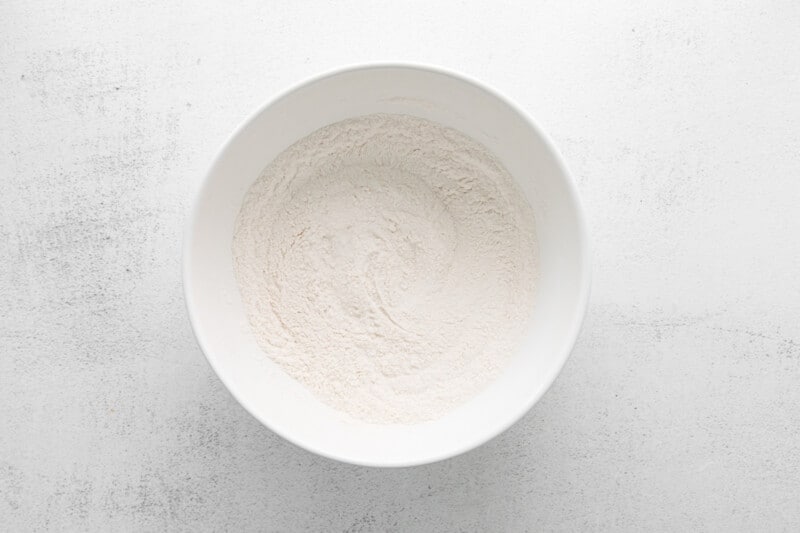 dry ingredients for funfetti donuts in a white bowl