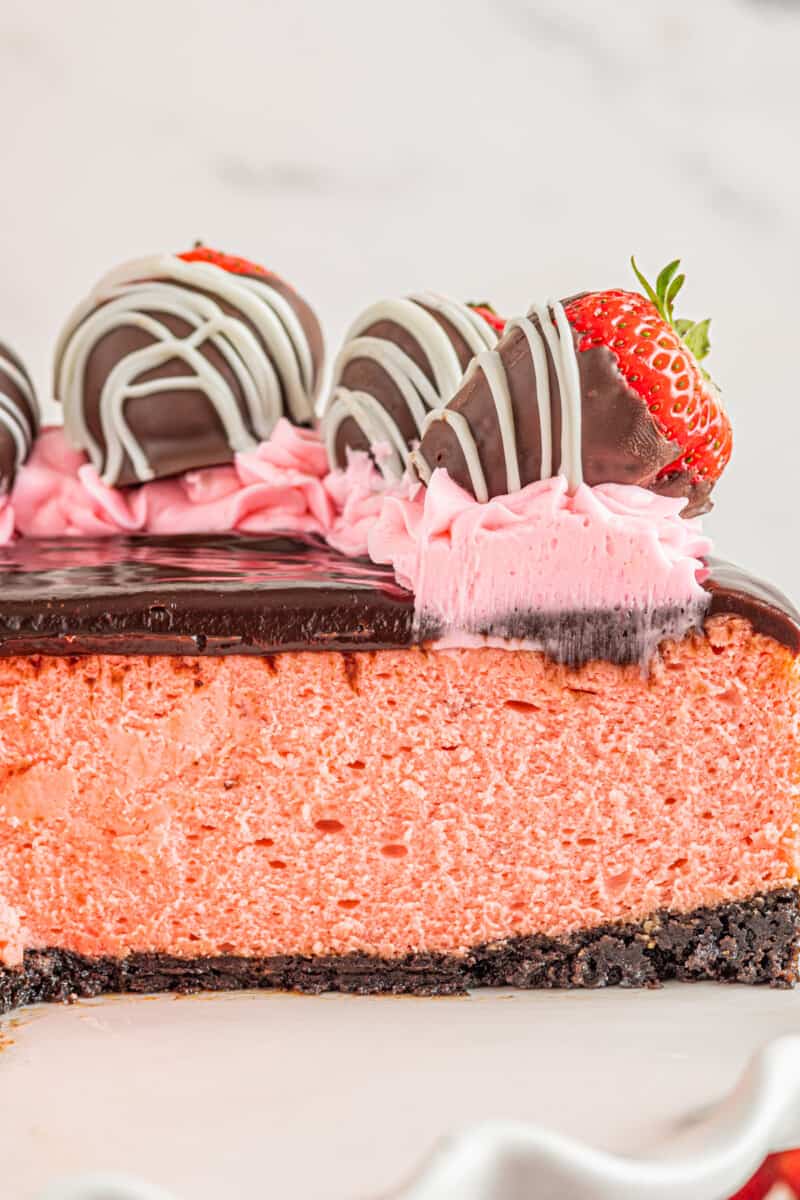 close up view of sliced chocolate covered strawberry cheesecake.