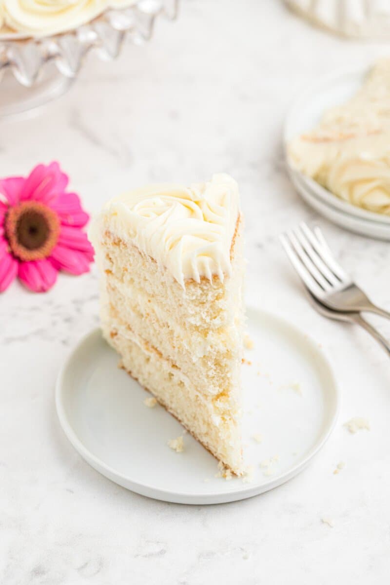a slice of easy homemade wedding cake on a white plate with a fork.