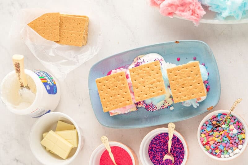assembled cotton candy s'mores on a blue plate