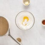 egg yolks and cornstarch for eggnog pie in a glass bowl.