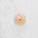 overhead view of strawberry shortcake cupcake topping in a glass bowl.