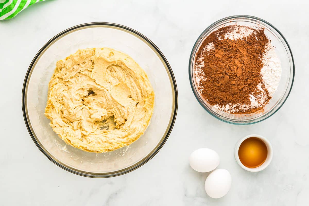 creamed butter and sugar for andes mint cookies in a glass bowl.