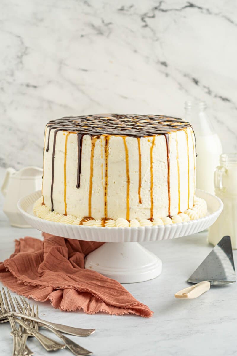 chocolate caramel ombre cake on a white cake stand.