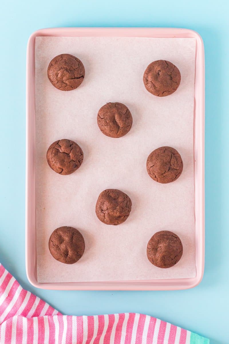 8 chocolate pudding cookies on a baking sheet.