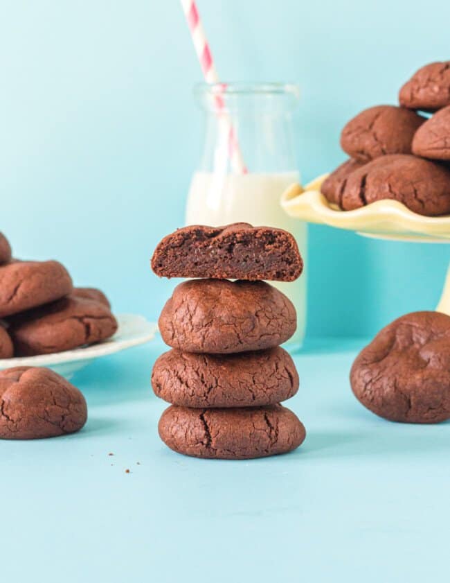 halved chocolate pudding cookie stacked on 3 chocolate pudding cookies.