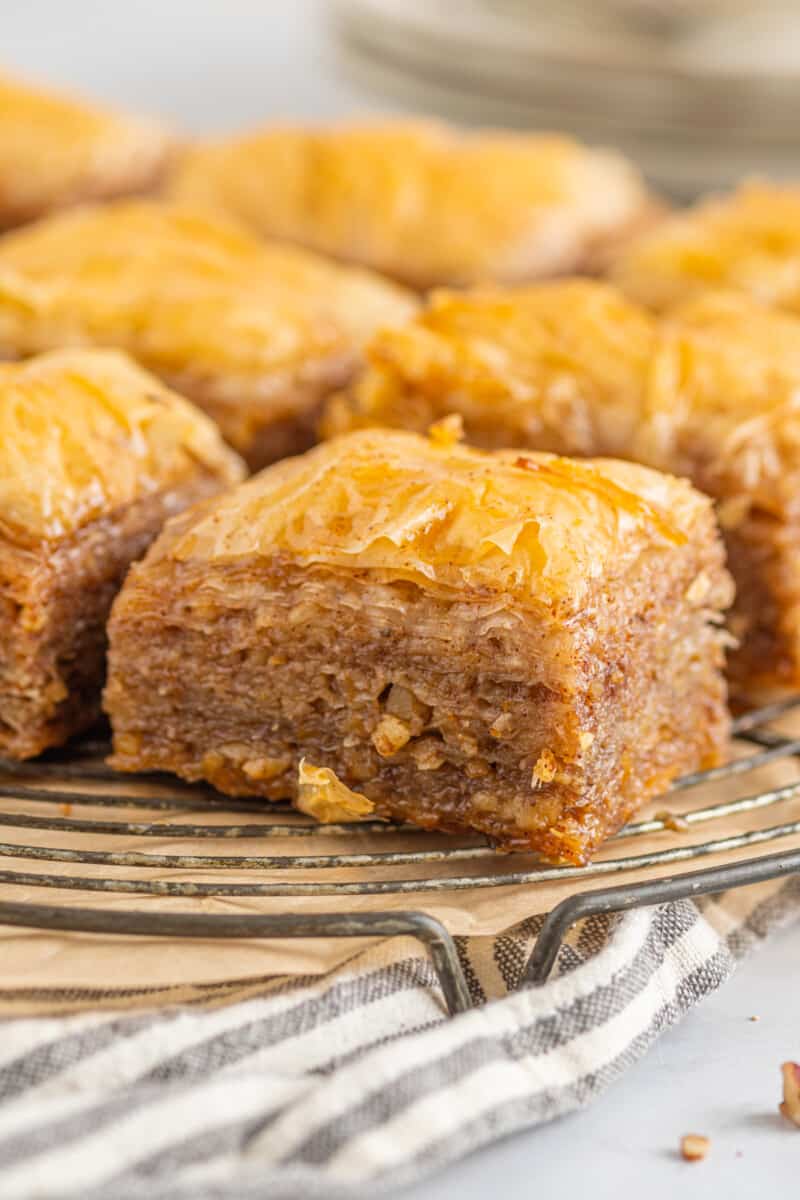 squares of homemade baklava on a circular wire rack.