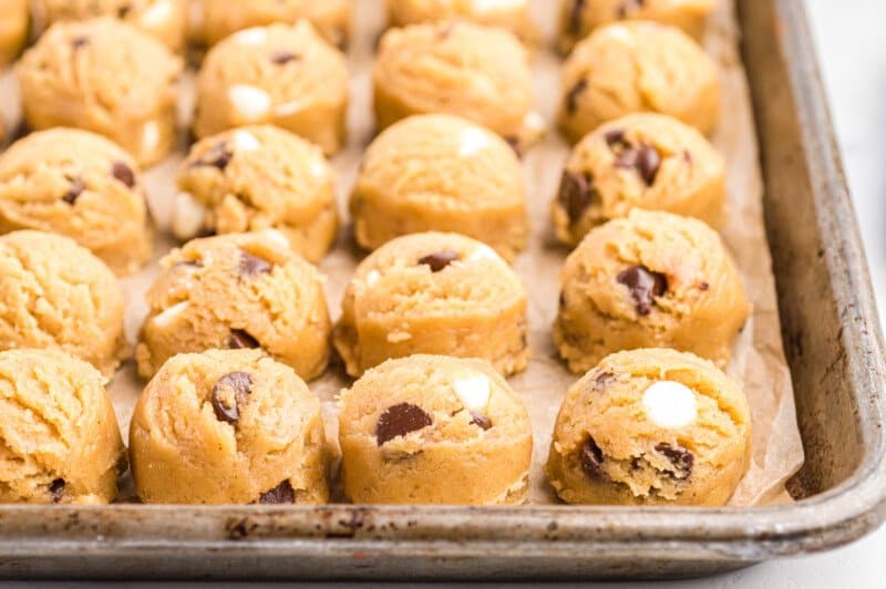 brown butter chocolate chip cookie dough balls on a baking sheet.