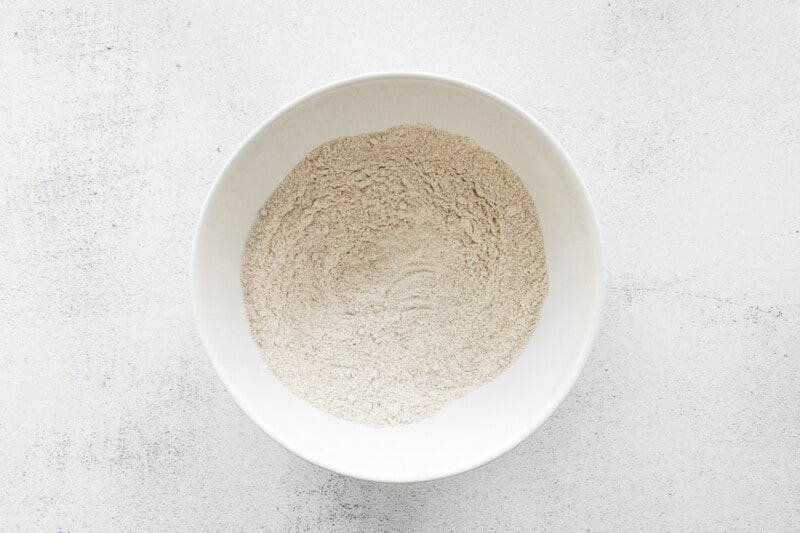 dry ingredients for chai cupcakes in a white bowl.