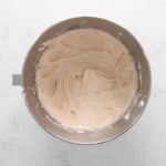cinnamon swirl cupcake frosting in a stainless mixing bowl.
