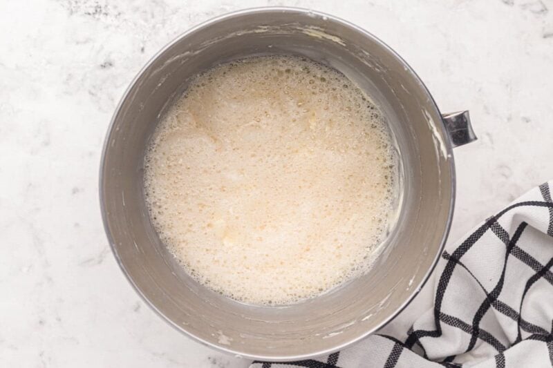 foamy egg whites in a stand mixer bowl.